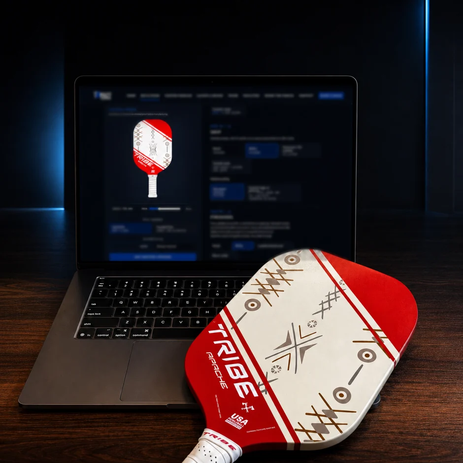 A TRIBE paddle being specified in the iMPACT Build Room on a laptop, beside the finished manufactured paddle