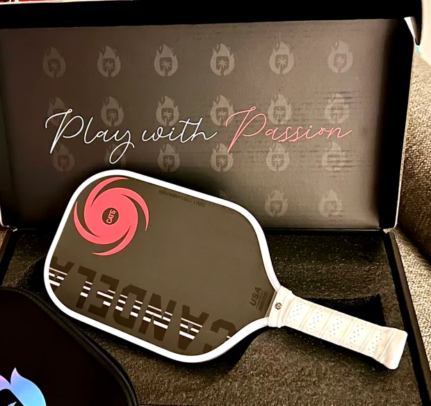 A Candela branded retail box open with the matching paddle and zip cover